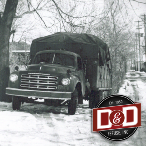 A vintage D&D Refuse Inc. truck with a canvas cover, parked in the snow in Lincoln, NE.