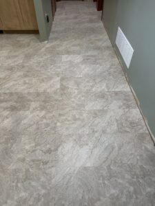 Newly installed light grey marble-look vinyl flooring in a hallway by Creative Carpets in North Las Vegas, NV.