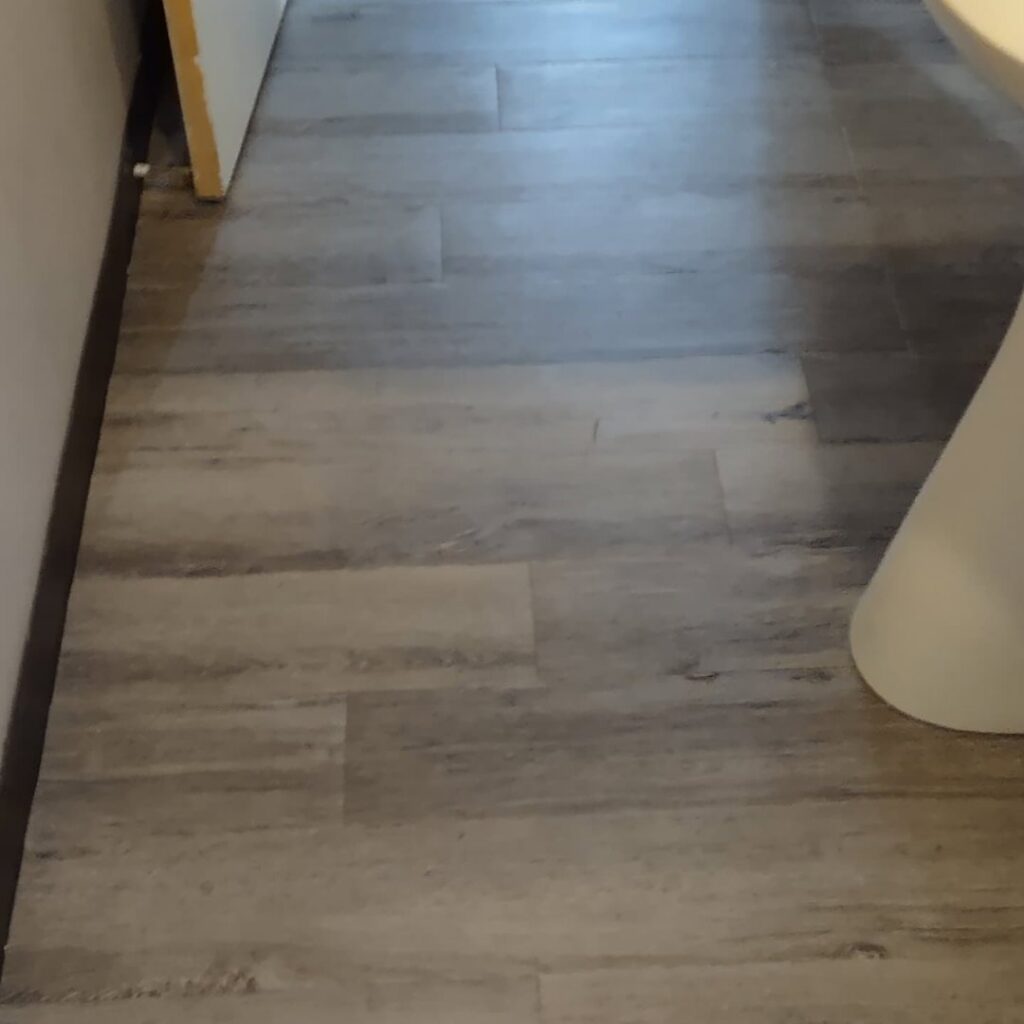 Newly installed vinyl plank flooring in a room by Handyashby in Saint Joseph, MO.