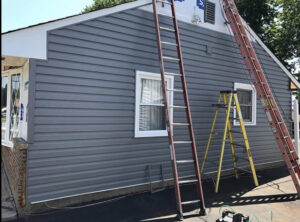 New grey vinyl siding being installed on a house exterior by S-G General Contracting LLC in Philadelphia, PA.