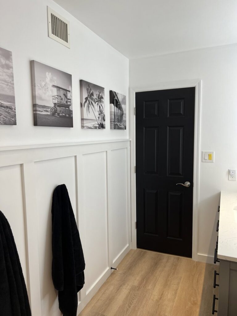 Wainscoting and door installation in a hallway by Jocia Construction Services in Gilbert, AZ.