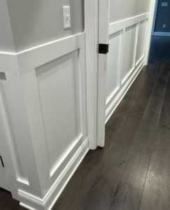 Newly installed wainscoting and trim work on a wall by Handy Dad's in Seminole, FL