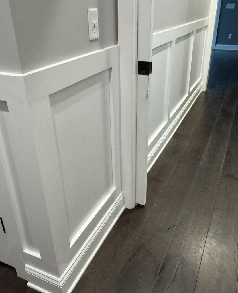 Newly installed wainscoting and trim work on a wall by Handy Dad's in Seminole, FL