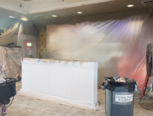 Interior room renovation showing wainscoting installation and protective plastic sheeting by RG Construction WA, LLC in Portland, OR.