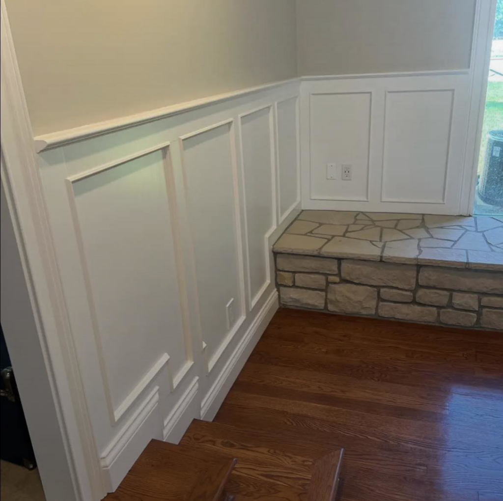 Wainscoting installation and painting with a stone bench by Rock Creek Renovation and Painting in Waynesville, OH