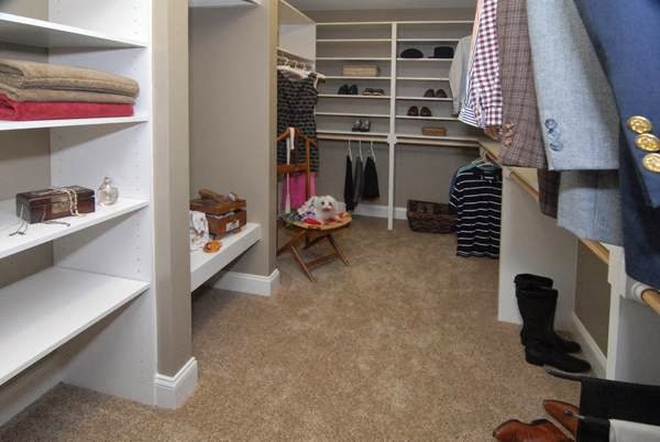 A spacious walk-in closet with custom shelving and organization by Rothrock Renovation & Remodeling in Winston-Salem, NC