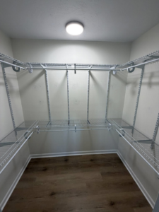 A completed wire shelving system installation in a walk-in closet by HandyWorx Home Services LLC in Kenna, WV.