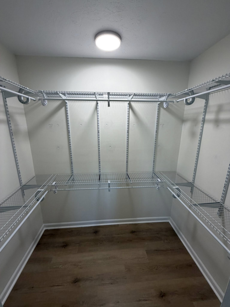A completed wire shelving system installation in a walk-in closet by HandyWorx Home Services LLC in Kenna, WV.