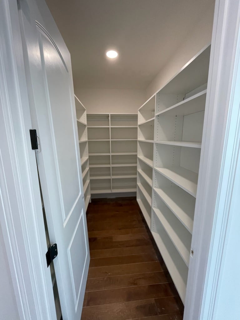 Walk-in pantry with white shelving units installed by Thermal Concepts, Inc in St. Louis, MO.