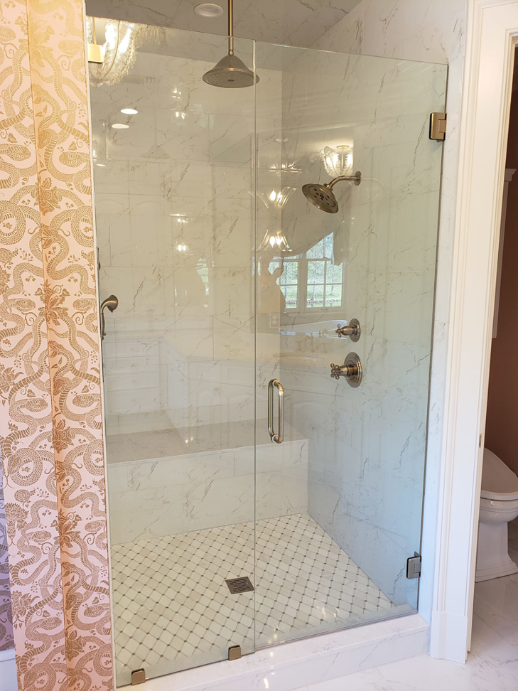 A newly installed walk-in shower with glass doors and custom tiling by Kenneth C. Bergeron, Architect in Pollock, LA.