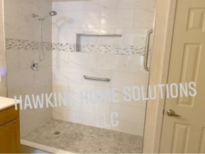 A newly installed walk-in shower with modern tiling and grab bars by Hawkins Home Solutions LLC in Glendale, AZ.