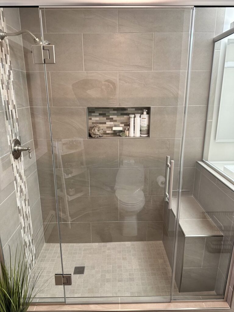 Beautiful walk-in shower installation with tiled walls and bench by Top Notch Contracting in Racine, WI.