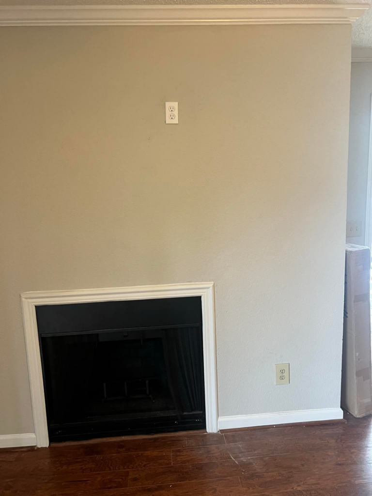 A living room wall above a fireplace, prepared for TV mounting by Gardner Home Services in Pleasant Grove, AL.