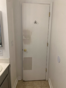 A wall or cabinet with a rectangular cutout and wood panels, indicating custom installation or repair work by Rock Solid Handyman Services in Sparks, NV.