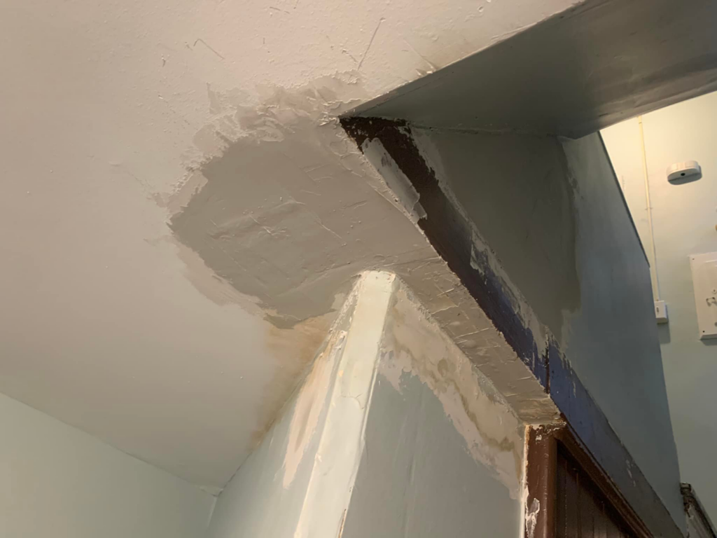 A wall and ceiling corner with fresh spackle and patching, showing repair work in progress by PG Painting and Contracting Services in Cincinnati, OH.