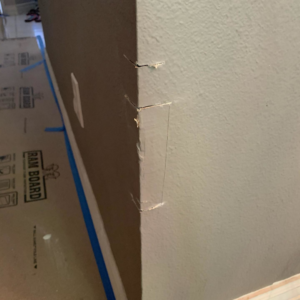 A wall corner showing cuts and damage, prepared for repair work by Island Handyman in Honolulu, HI.