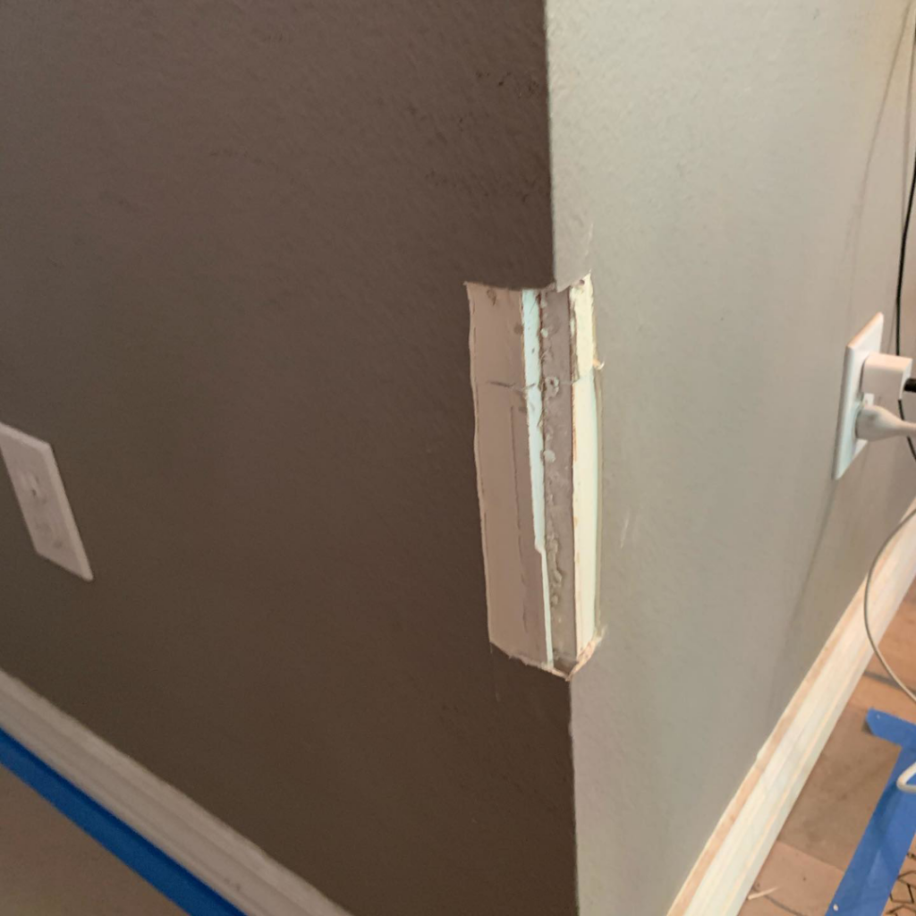 A wall corner with spackle applied over cuts, showing repair work in progress by Island Handyman in Honolulu, HI.