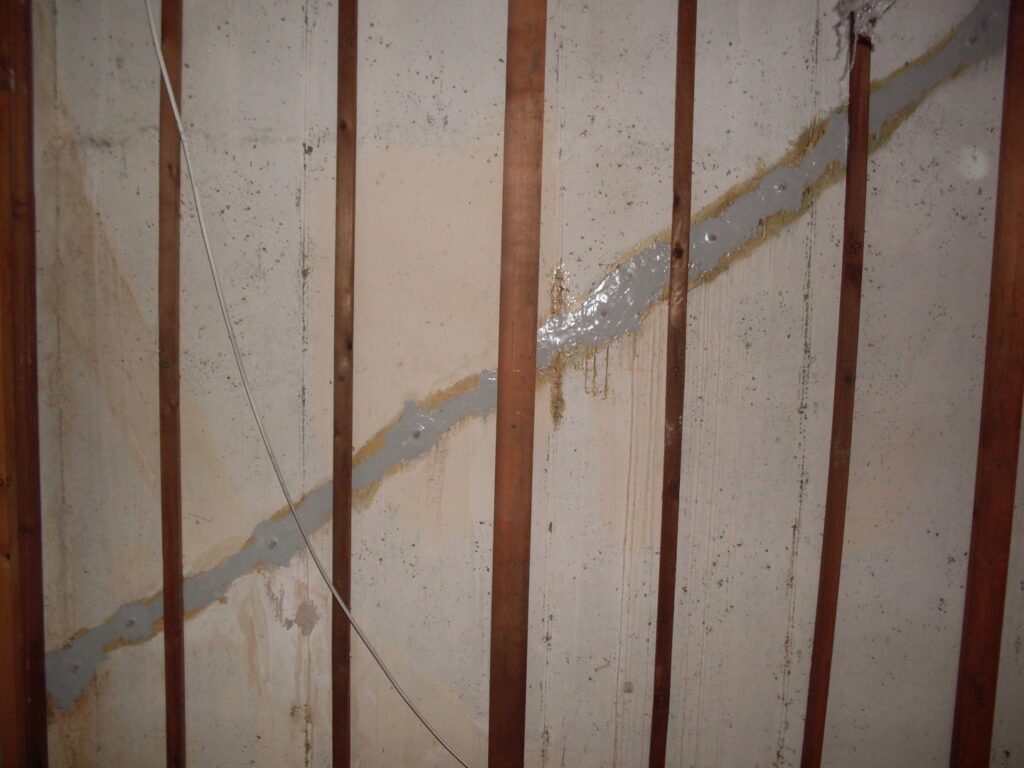 Wall crack repair with sealant and wooden studs by E.S. Leonard Waterproofing in De Soto, MO.