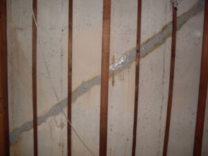 Wall crack repair with sealant and wooden studs by E.S. Leonard Waterproofing in De Soto, MO.
