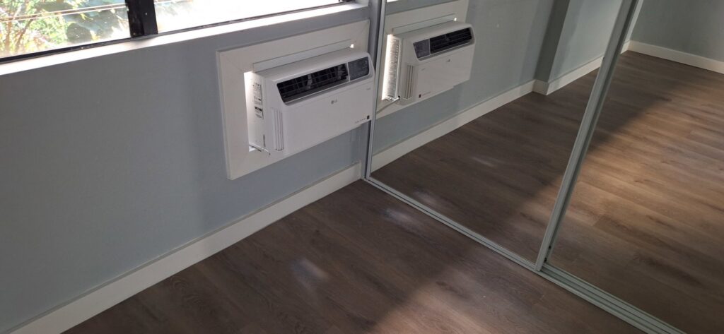 Two wall-mounted air conditioning units installed in a room with new flooring by Just-In-Time Handyman Services in Honolulu, HI.