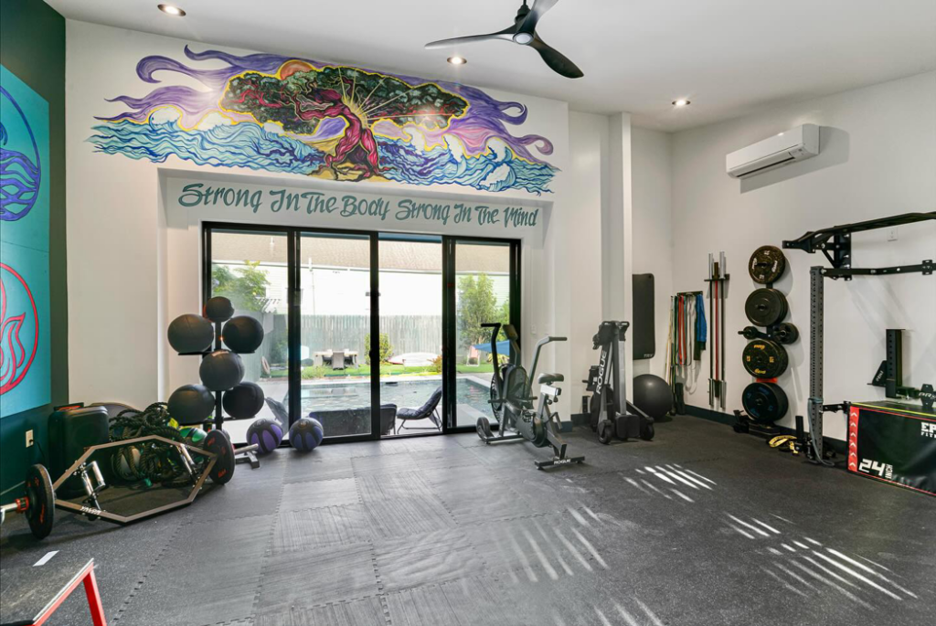 Installation of a wall-mounted AC unit in a home gym by Sweeney Restoration, LLC, serving New Orleans, LA.