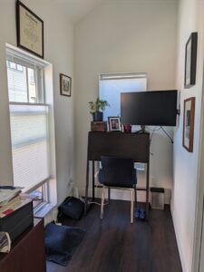 Home office with a wall-mounted monitor and window blinds, demonstrating installation services by Radiant Homes LLC in Denver, CO.