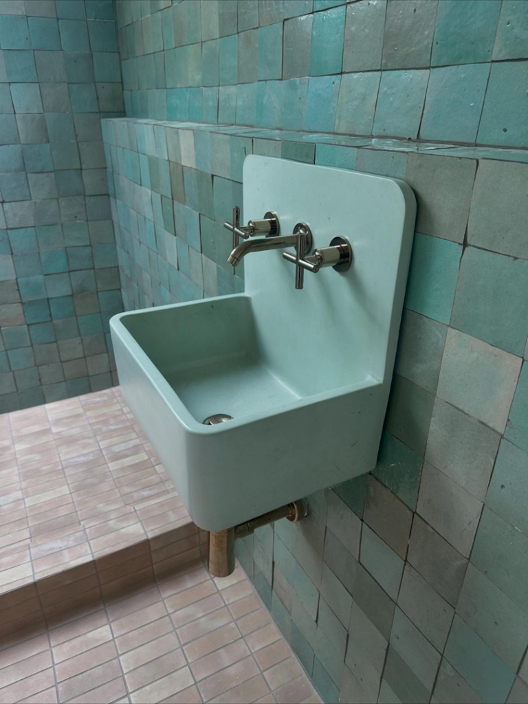 Professional installation of a wall-mounted sink and faucet by Sweeney Restoration, LLC in New Orleans, LA.