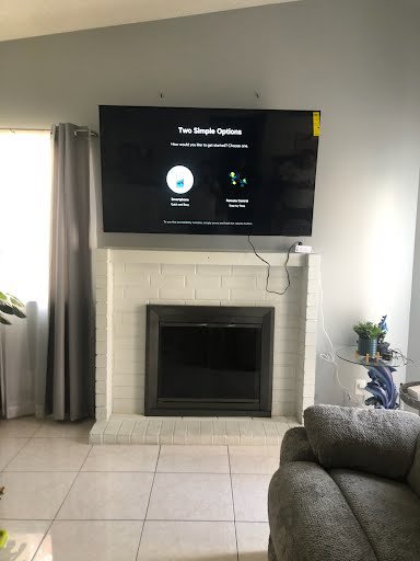 A large television professionally mounted above a fireplace by Vegas Valley Remodeling/Handy-Man Services in Las Vegas, NV.