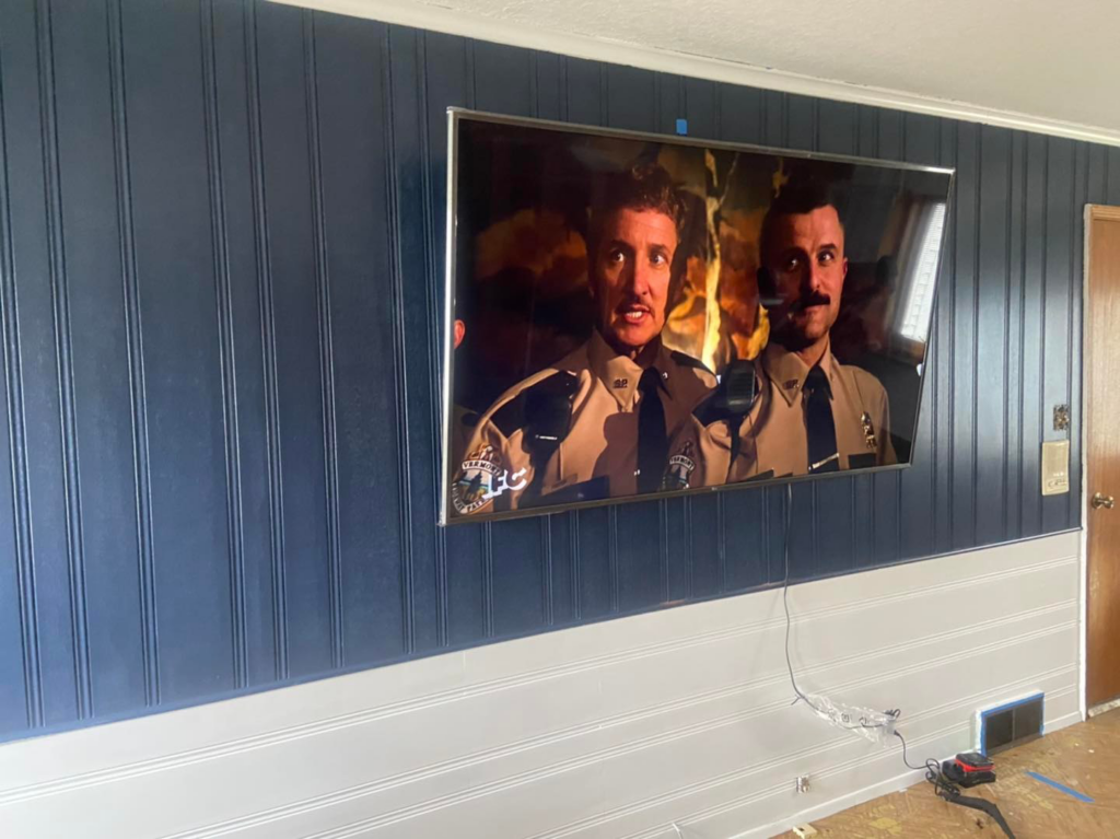 Professional wall-mounted TV installation and beadboard paneling by Smith Construction Managment in Fort Wayne, IN.