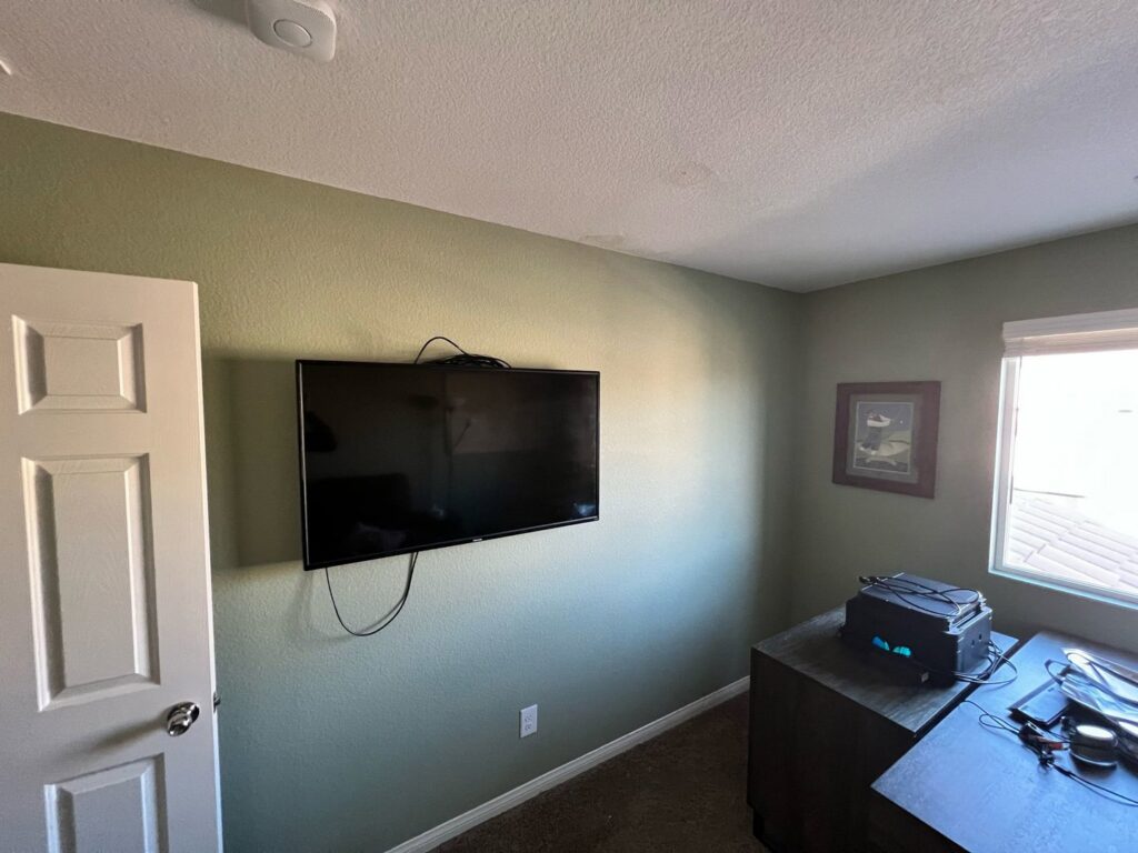 A professionally wall-mounted television in a room, installed by Vegas Valley Remodeling/Handy-Man Services in Las Vegas, NV.