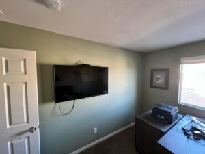 A professionally wall-mounted television in a room, installed by Vegas Valley Remodeling/Handy-Man Services in Las Vegas, NV.