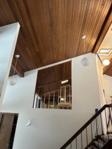 A large wall opening revealing interior framing during a renovation project by Haus Builders in Goodhue, MN