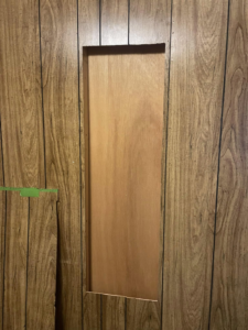 A handyman performing wall paneling repair for Infinity Maintenance Services, Inc. in Brattleboro, VT.