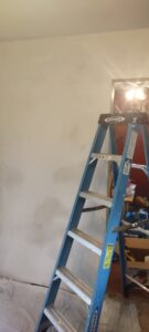 A ladder against a wall prepped for painting or drywall repair by Handyashby in Saint Joseph, MO.