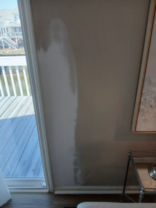 A wall showing repair work and preparation for painting by Southeastern Painting & Drywall in Wilmington, NC