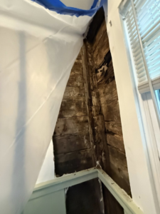 Exposed wooden wall studs and plastic sheeting indicating repair or preparation work by NorthStar Insulating Systems, Inc. in Hermantown, MN.