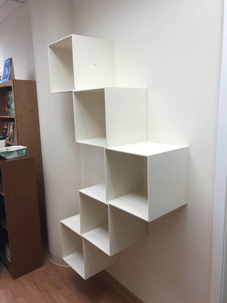 Professional wall shelf installation by Trusted Handyman in Honolulu, HI, showcasing neatly mounted white cube shelves.