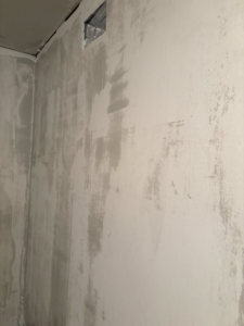 A wall freshly covered with drywall mud, demonstrating expert drywall repair services by Byrd Property Restoration, LLC in Parkersburg, WV.