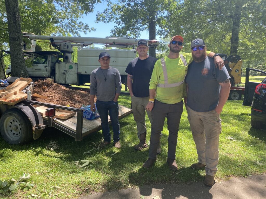 The dedicated team of Wallace Tree Service with their equipment at a job site in Russellville, AL, ready for tree care.