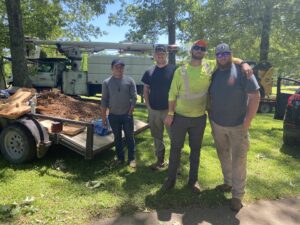 The dedicated team of Wallace Tree Service with their equipment at a job site in Russellville, AL, ready for tree care.