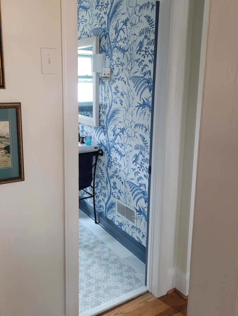 A beautifully wallpapered bathroom with new tile flooring installed by Williamson Flooring & Design Center in Rock Hill, SC