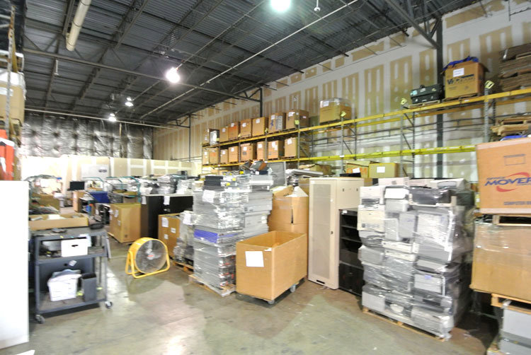 A warehouse filled with various IT assets, computers, and electronics ready for recycling by Securis in Greensboro, NC