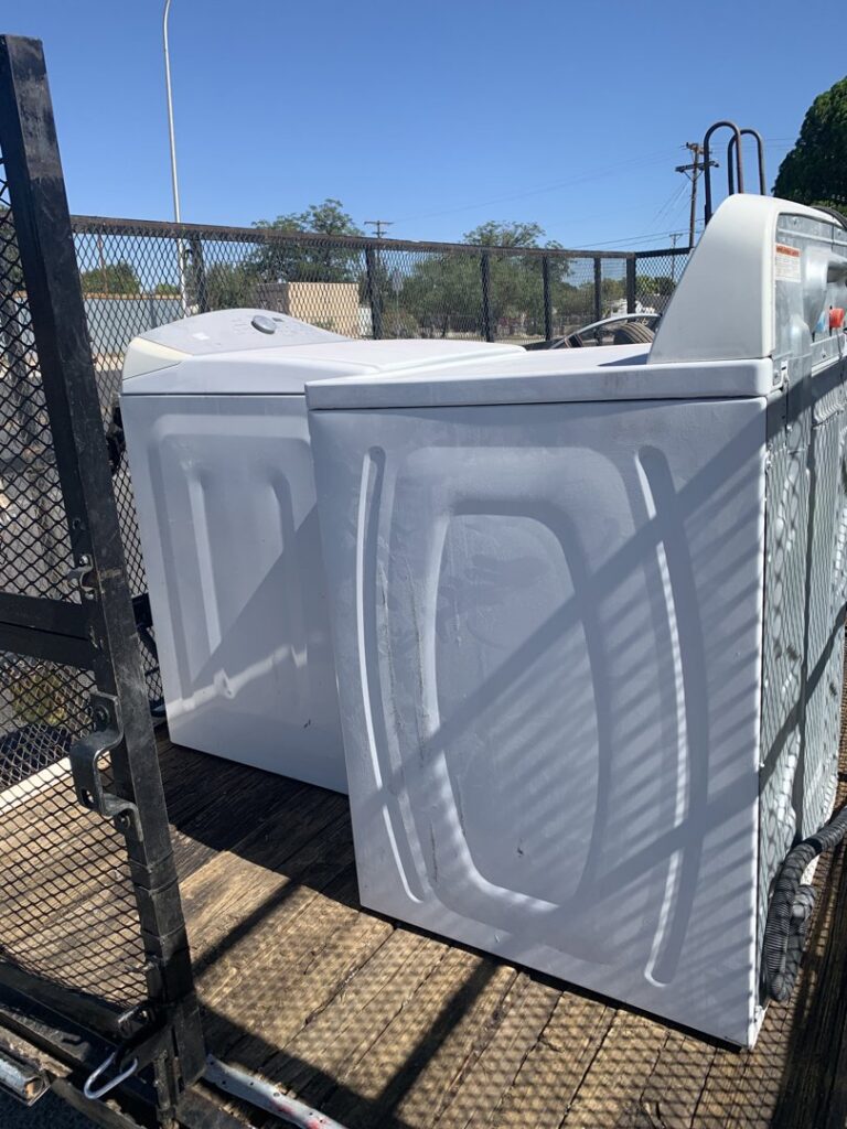 A washer and dryer loaded onto a trailer for removal by Roadrunner JunkSmart Solutions LLC in Las Cruces, NM.