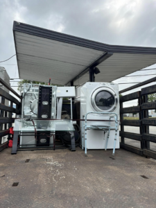 A truck loaded with a washing machine and other appliance parts for junk hauling by Allen's Junk Removal & Hauling in Smyrna, TN.
