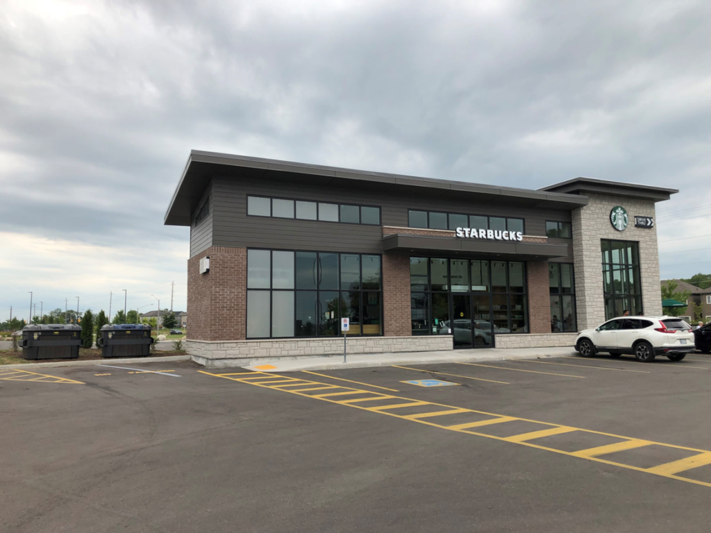 Large waste and recycling bins in a Starbucks parking lot provided by Binova Group in Knoxville, TN.