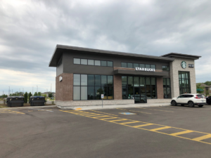 Large waste and recycling bins in a Starbucks parking lot provided by Binova Group in Knoxville, TN.