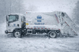 A Champion Waste Services waste collection truck operating in the snow in Londonderry, NH.