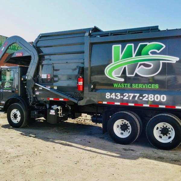 A large commercial waste collection truck from Waste Services, LLC, ready for service in Charleston, SC.