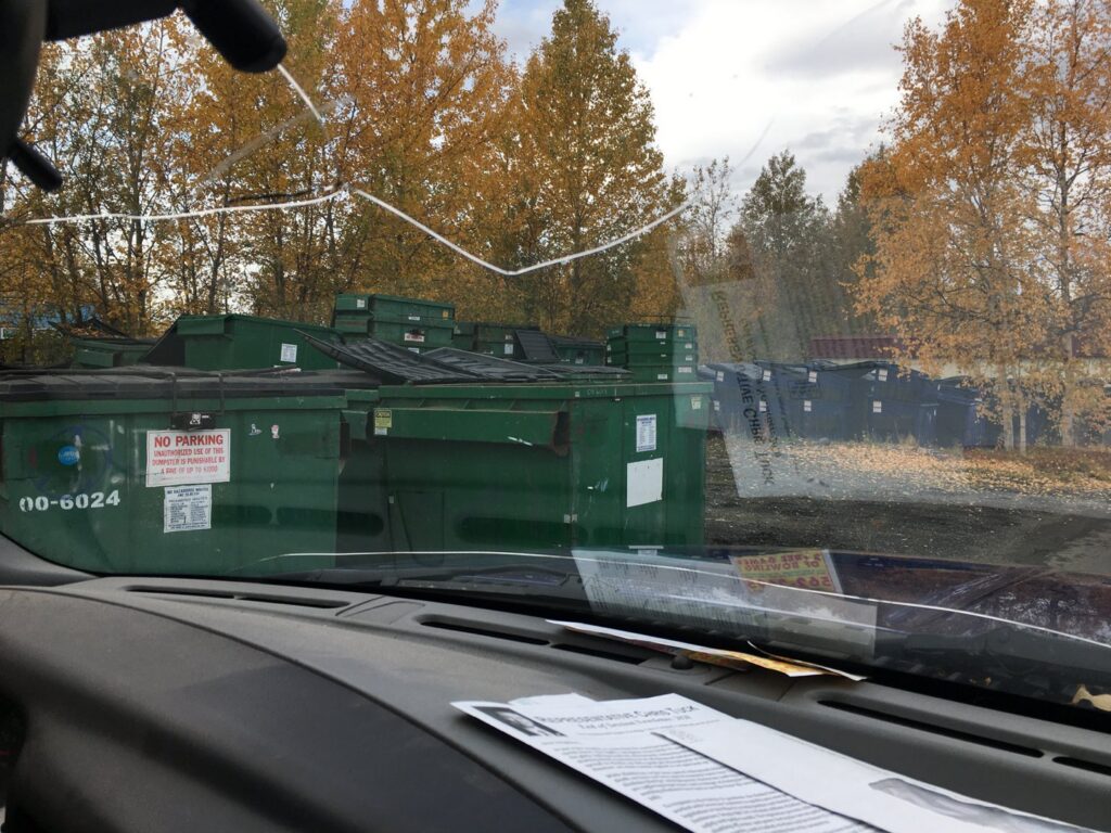 Large green waste dumpsters in a collection area by Anchorage Solid Waste Services in Anchorage, AK.