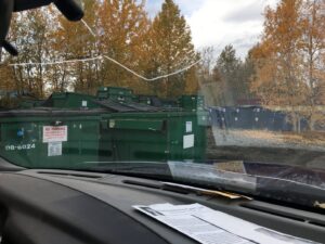 Large green waste dumpsters in a collection area by Anchorage Solid Waste Services in Anchorage, AK.